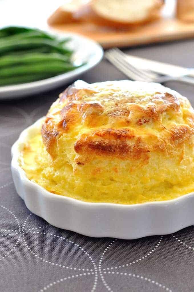 Souffle you can make ahead - freezer and refrigerator friendly. Cheesy, light as air souffl&eacute; covered in a luscious creamy sauce. And easy!
