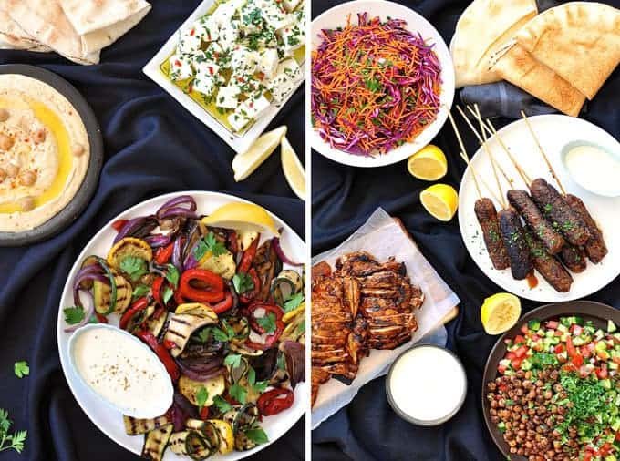 Table filled with dishes for an Arabian Feast / Middle Eastern Menu, with dishes including Chicken Shawarma, lamb kaftas, hummus, chickpea salad.