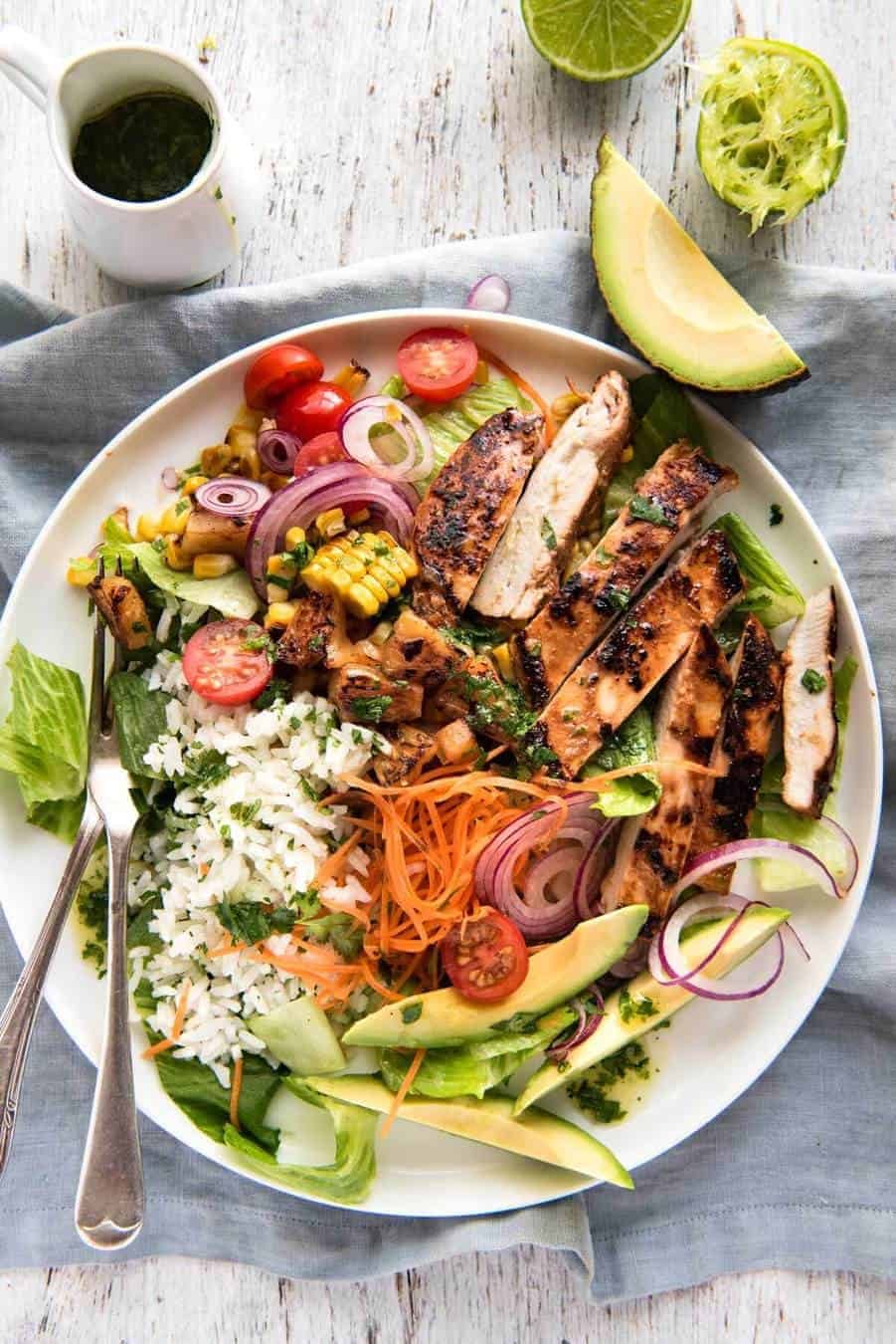 A salad with chicken marinated in pineapple juice, coconut milk & spices and a beautiful cilantro (coriander) lime dressing. The flavours of Hawaii - in a salad! dev.recipetineats.com