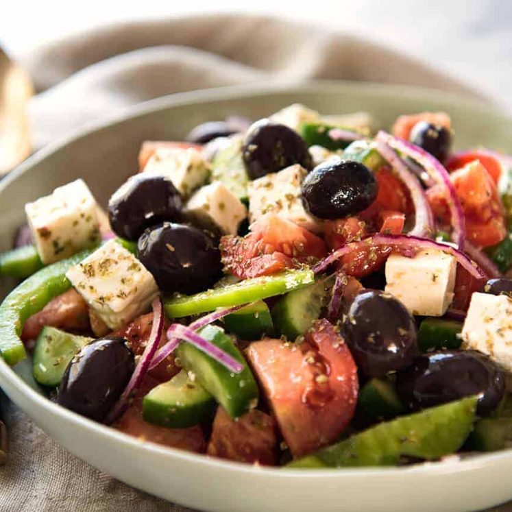 A classic Greek Salad with plump olives and a beautiful homemade Greek Salad Dressing. dev.recipetineats.com