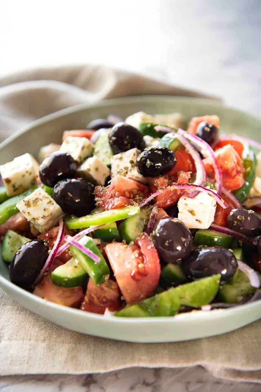 A classic Greek Salad with plump olives and a beautiful homemade Greek Salad Dressing. dev.recipetineats.com