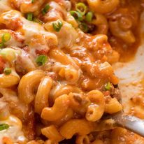 Close up of Cheeseburger Casserole - homemade Hamburger Helper - in a white cast iron skillet, fresh off the stove