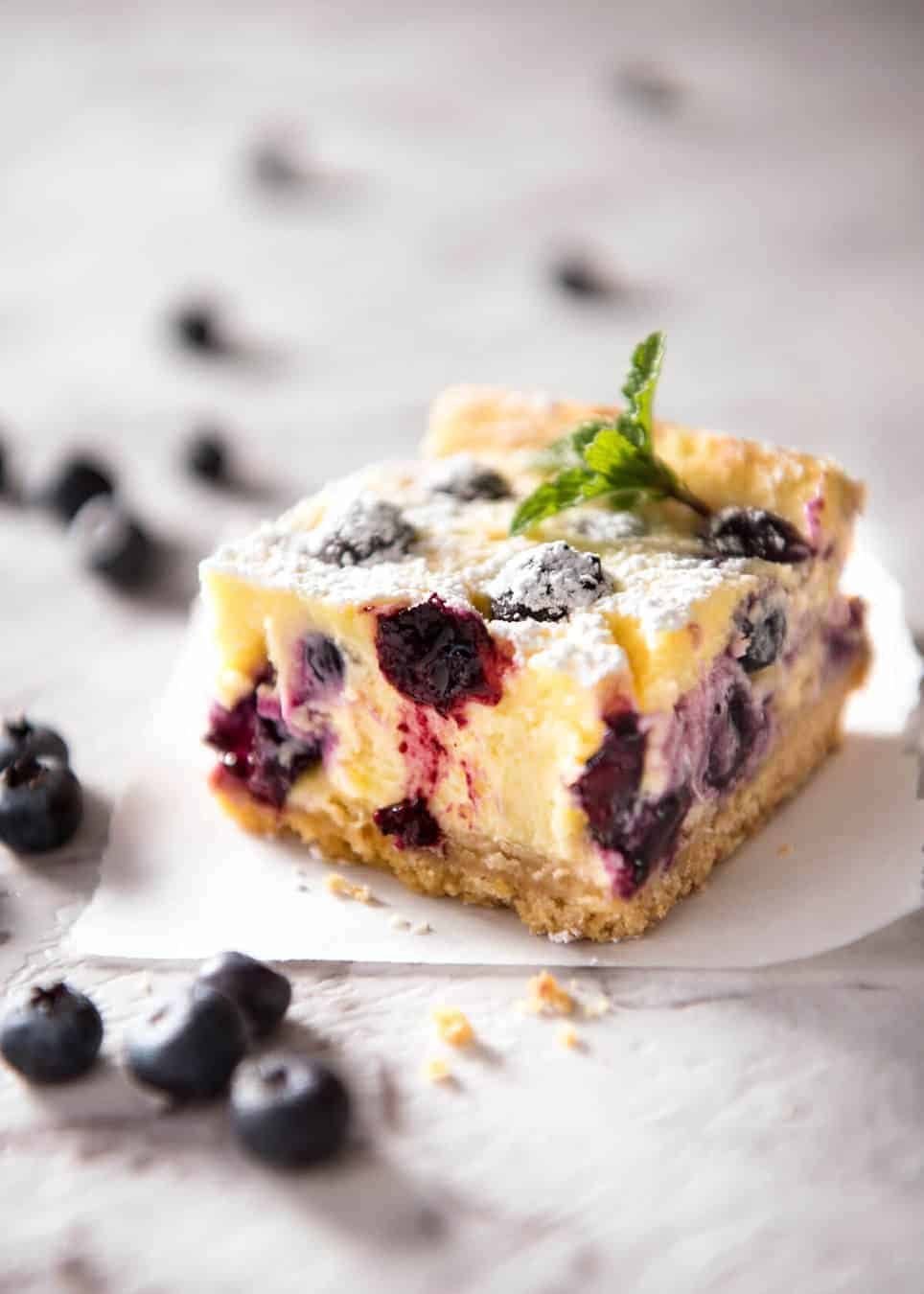 These Blueberry Cheesecake Bars are light yet creamy and luscious. Filled with soft blueberries, this is a baked cheesecake that's so easy to make! dev.recipetineats.com