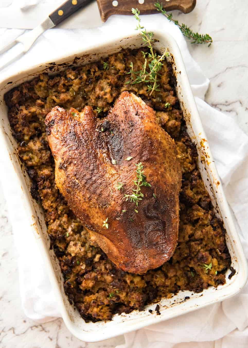 This Cajun dry brined turkey breast is baked in the same roasting pan as the Dressing / Stuffing so it's extra juicy and moist! A chef recipe, this Cajun Baked Turkey Breast with Dressing is easy and spectacular. EPIC ONE PAN COOKING for a Thanksgiving turkey! dev.recipetineats.com