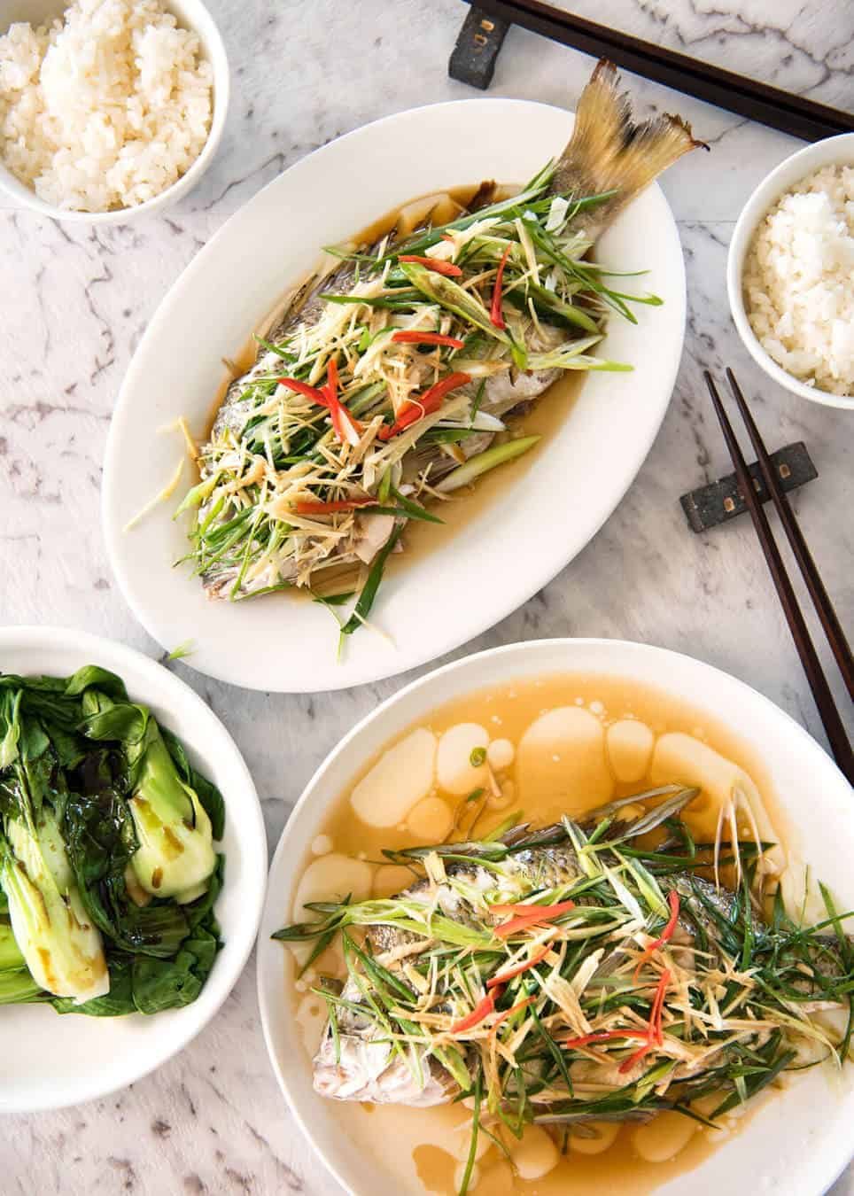 A Chinese Steamed Fish topped with Ginger and Shallots and seasonings, with hot oil poured over it to create a dramatic sizzle and an amazing sauce. So simple, yet so utterly delicious. Steam OR bake the fish! dev.recipetineats.com
