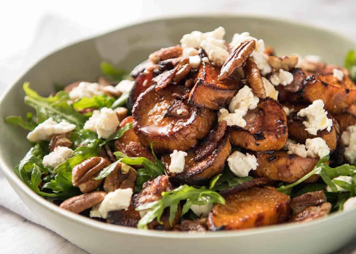 Roasted Sweet Potato Salad - with arugula/rocket, pecans, goats cheese or feta, a sprinkle of bacon and a beautiful Honey Lemon dressing. dev.recipetineats.com