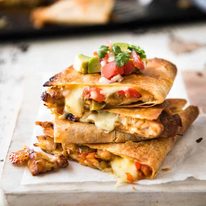 Crispy Oven Baked Chicken Quesadillas - This is how to make multiple Quesadillas at the same time! Crispy on the outside, stuffed with Mexican seasoned chicken and capsicum / bell peppers (and cheese of course!) dev.recipetineats.com