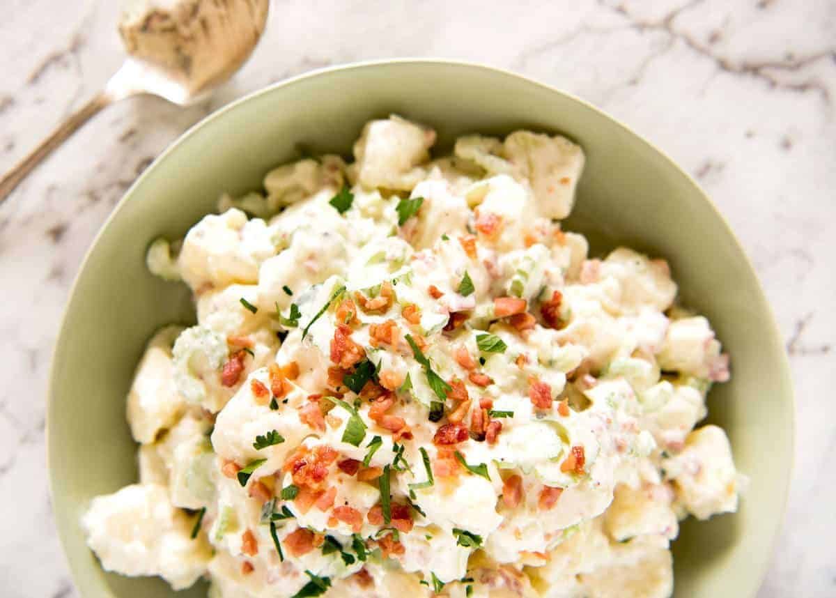 A classic potato salad made epic by pouring French dressing over the potatoes while cooked so it absorbs the flavour. The BEST potato salad I've ever had! dev.recipetineats.com