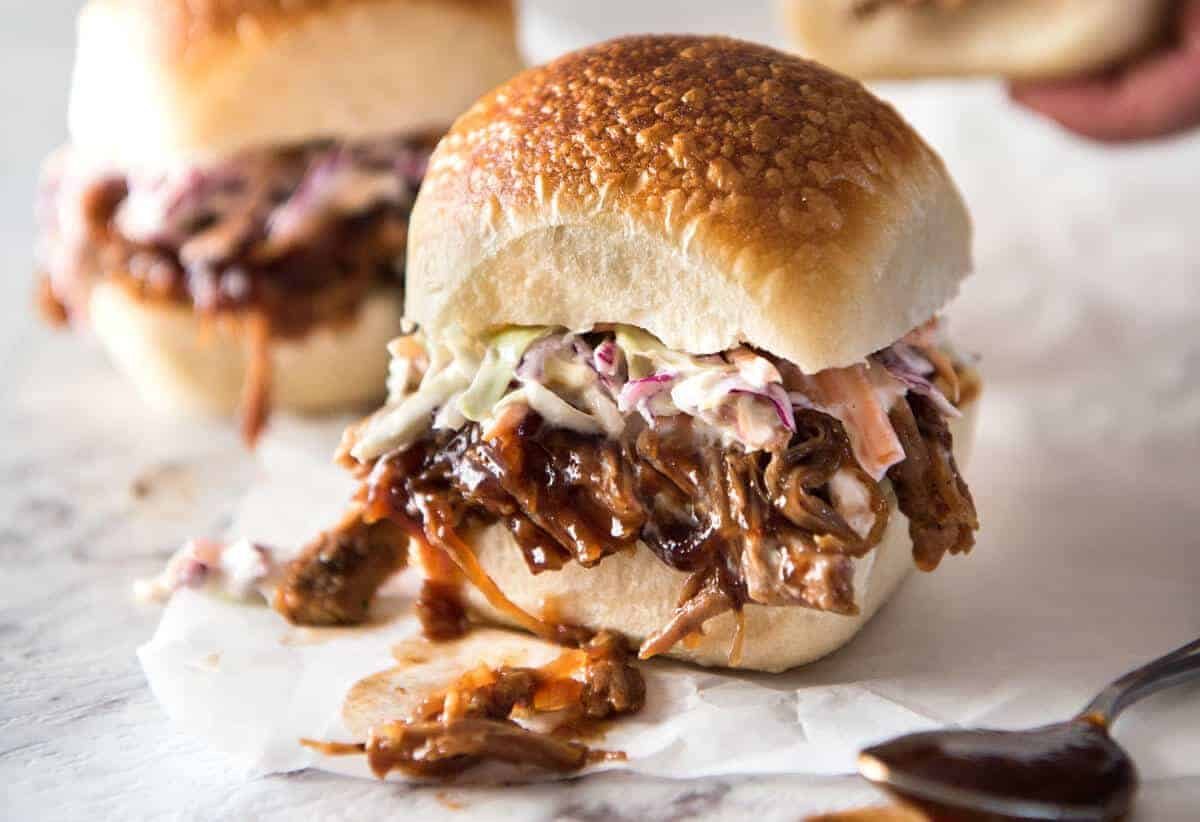 Slow Cooker BBQ Pulled Pork Sandwich - Perfectly seasoned, tender pulled pork tossed in a homemade BBQ sauce, piled onto bread with coleslaw. Slow cooker, pressure cooker or oven. dev.recipetineats.com
