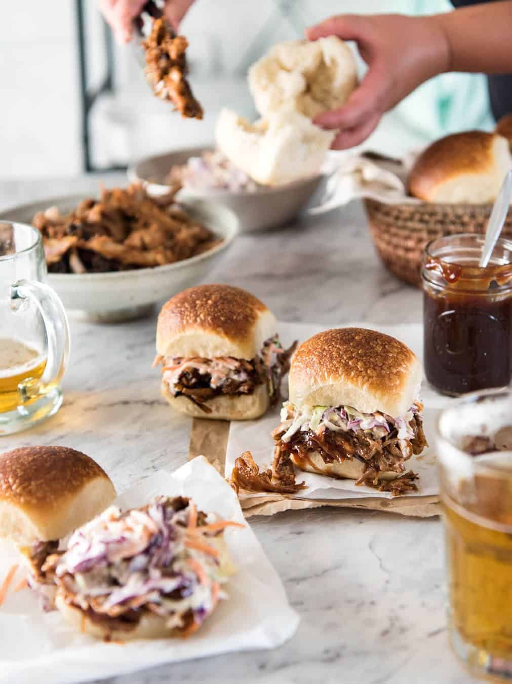 Slow Cooker BBQ Pulled Pork Sandwich - Perfectly seasoned, tender pulled pork tossed in a homemade BBQ sauce, piled onto bread with coleslaw. Slow cooker, pressure cooker or oven. dev.recipetineats.com