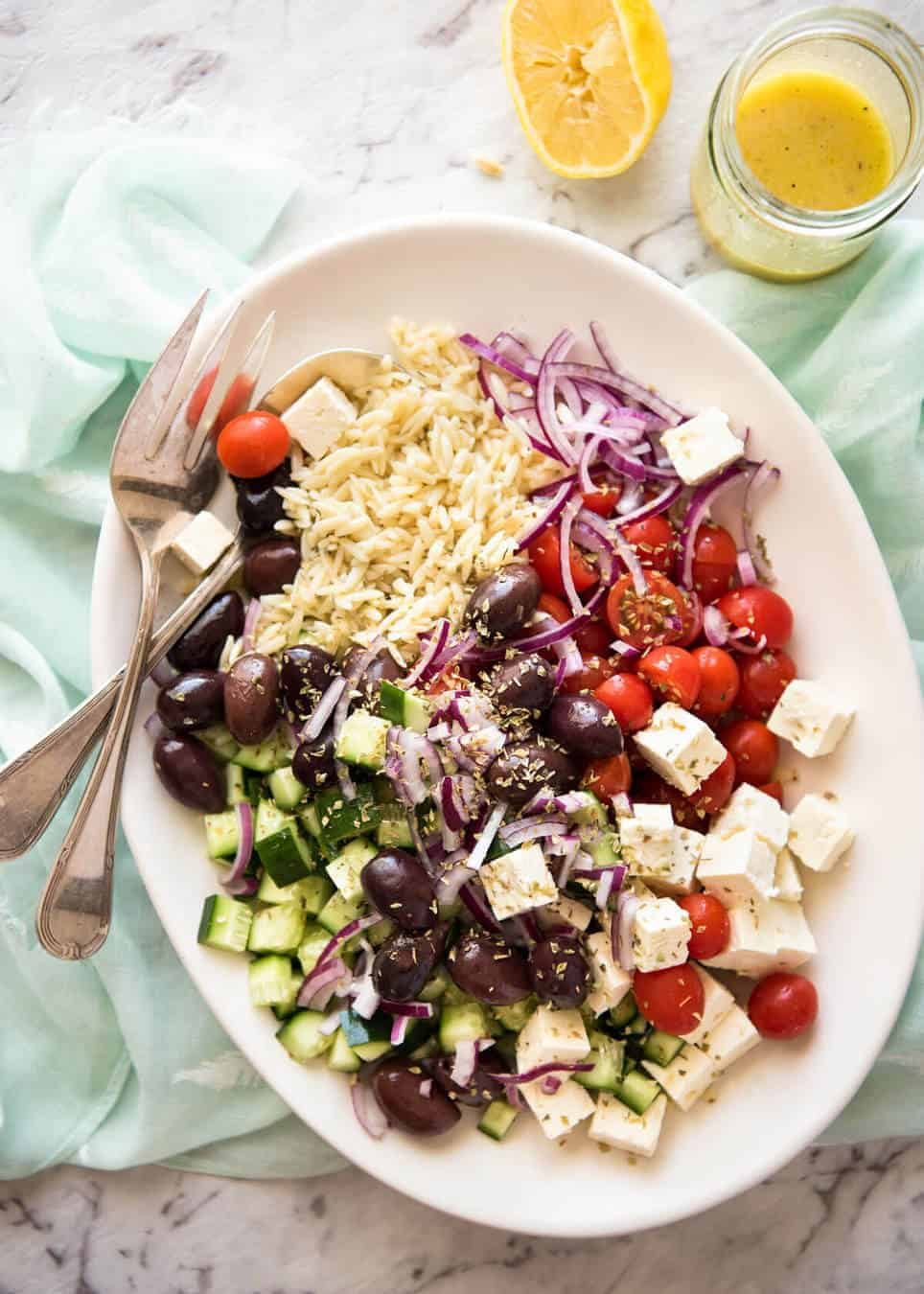 Greek Lemon Orzo Salad (Risoni) - All the fixings of a Greek Salad tossed through orzo / risoni and dressed with a gorgeous zesty lemon vinaigrette. dev.recipetineats.com