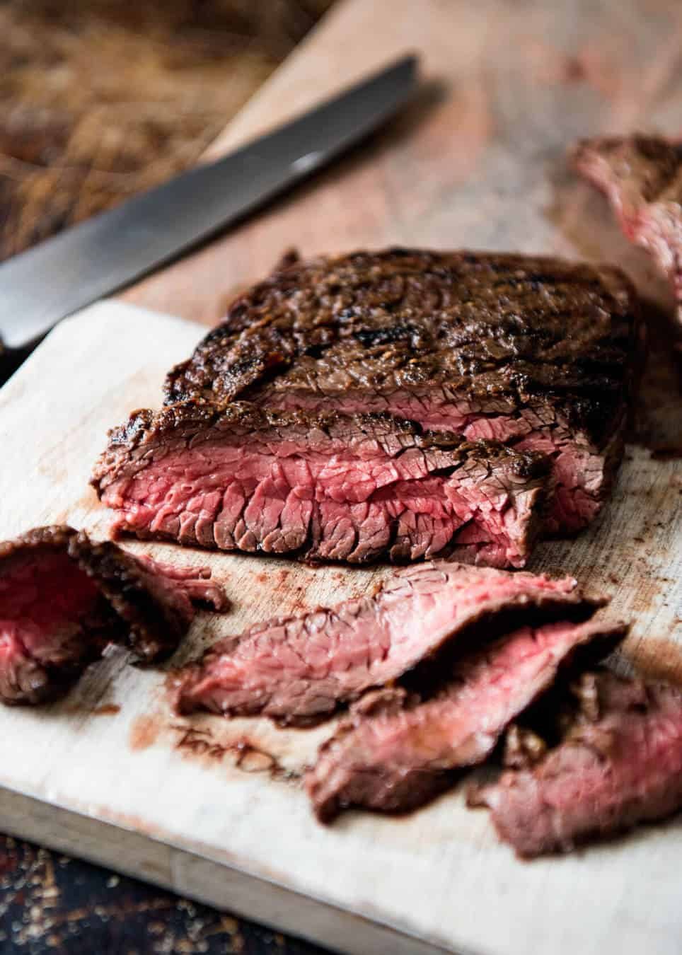 A juicy Steak Sandwich loaded with tender slices of steak, caramelised onion, garlic aioli, lettuce, tomato and mustard. dev.recipetineats.com