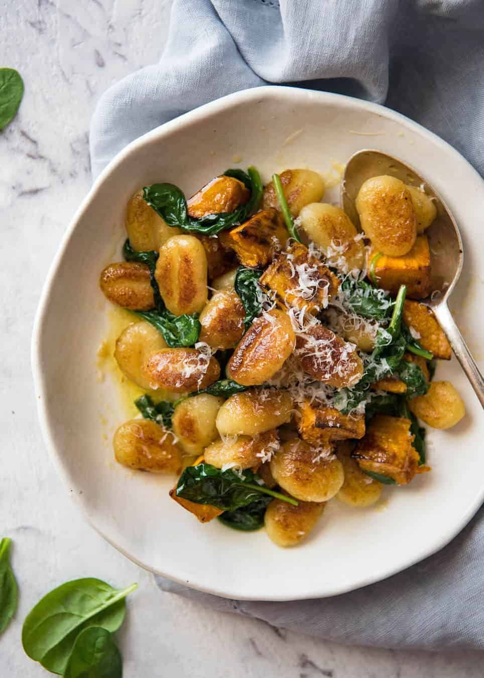 Pan Fried Gnocchi with Pumpkin and Spinach - Golden crispy on the outside, soft on the inside, with a butter sage sauce, roasted pumpkin and spinach. dev.recipetineats.com