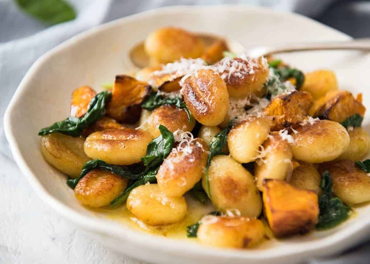 Pan Fried Gnocchi with Pumpkin and Spinach - Golden crispy on the outside, soft on the inside, with a butter sage sauce, roasted pumpkin and spinach. dev.recipetineats.com