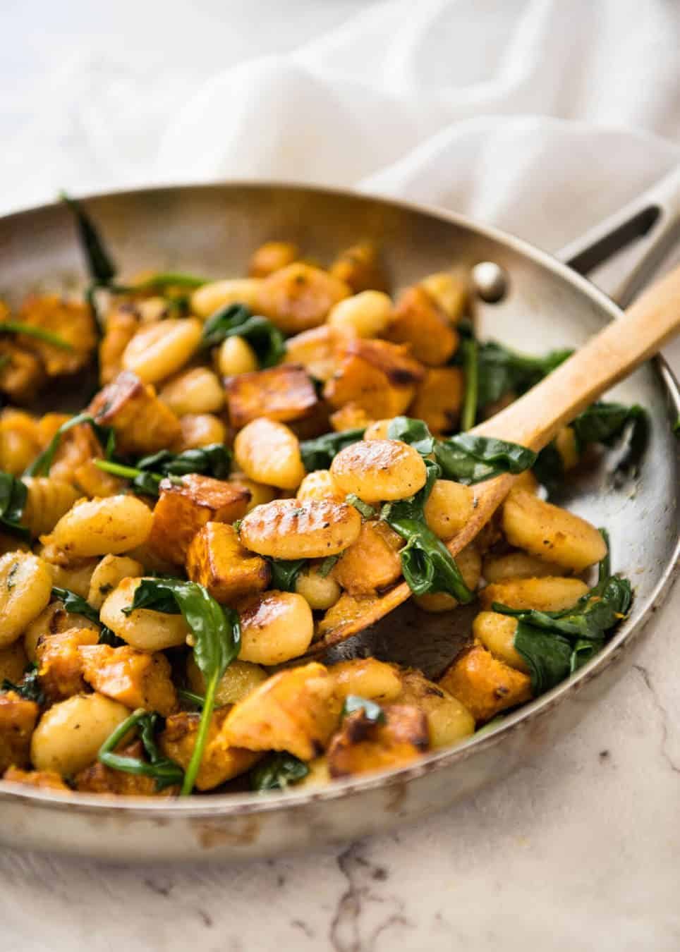 Pan Fried Gnocchi with Pumpkin and Spinach - Golden crispy on the outside, soft on the inside, with a butter sage sauce, roasted pumpkin and spinach. dev.recipetineats.com