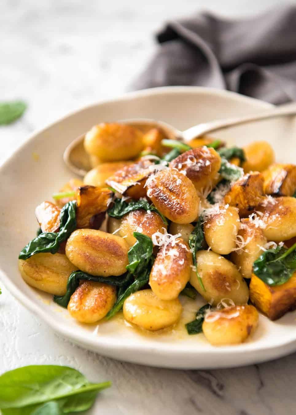 Pan Fried Gnocchi with Pumpkin and Spinach - Golden crispy on the outside, soft on the inside, with a butter sage sauce, roasted pumpkin and spinach. dev.recipetineats.com