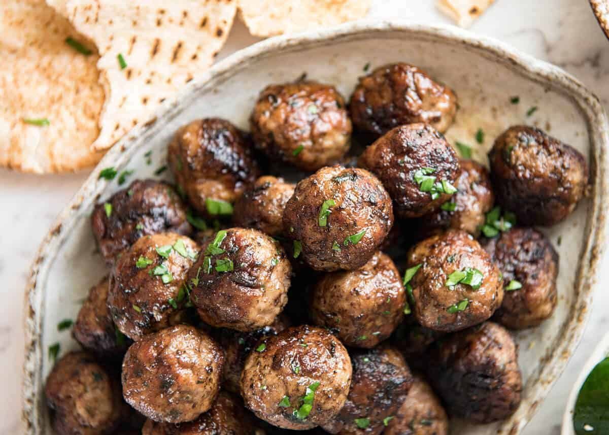 Soft, juicy, beautifully flavoured GREEK MEATBALLS! Serve as an appetiser with tzatziki, main with Greek Salad or make wraps! dev.recipetineats.com