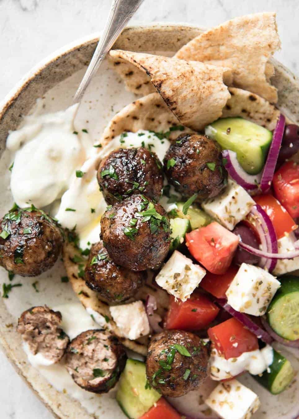 Soft, juicy, beautifully flavoured GREEK MEATBALLS! Serve as an appetiser with tzatziki, main with Greek Salad or make wraps! dev.recipetineats.com