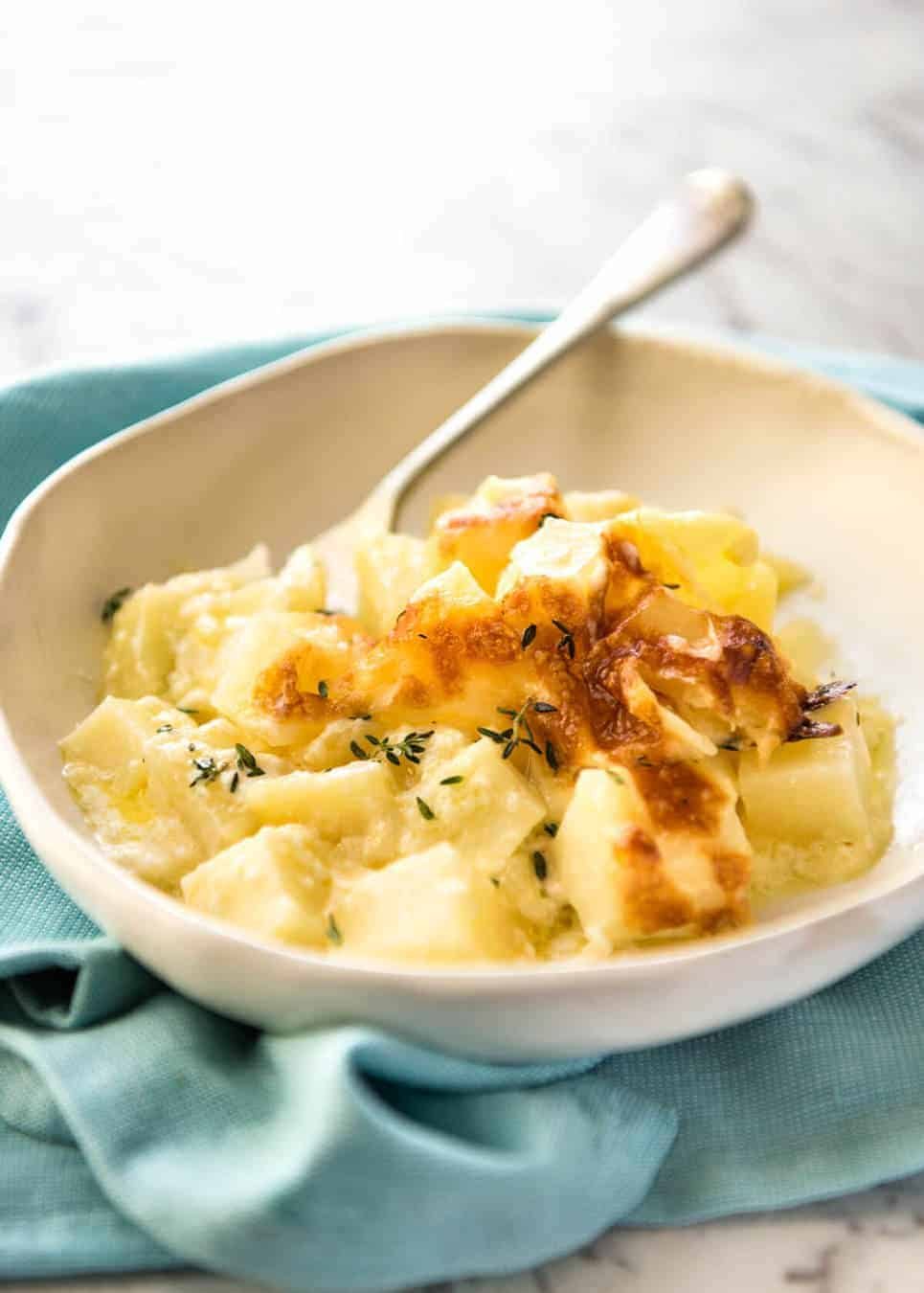 A faster, cheesier, creamier alternative to Scalloped Potatoes / Potato Gratin, this Easy Creamy Cheesy Potato Bake is made with cubed potatoes cooked in a cream and cheese sauce. dev.recipetineats.com