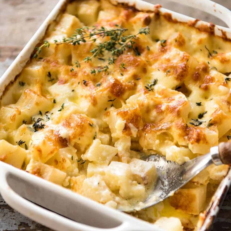 A faster, cheesier, creamier alternative to Scalloped Potatoes / Potato Gratin, this Easy Creamy Cheesy Potato Bake is made with cubed potatoes cooked in a cream and cheese sauce. dev.recipetineats.com