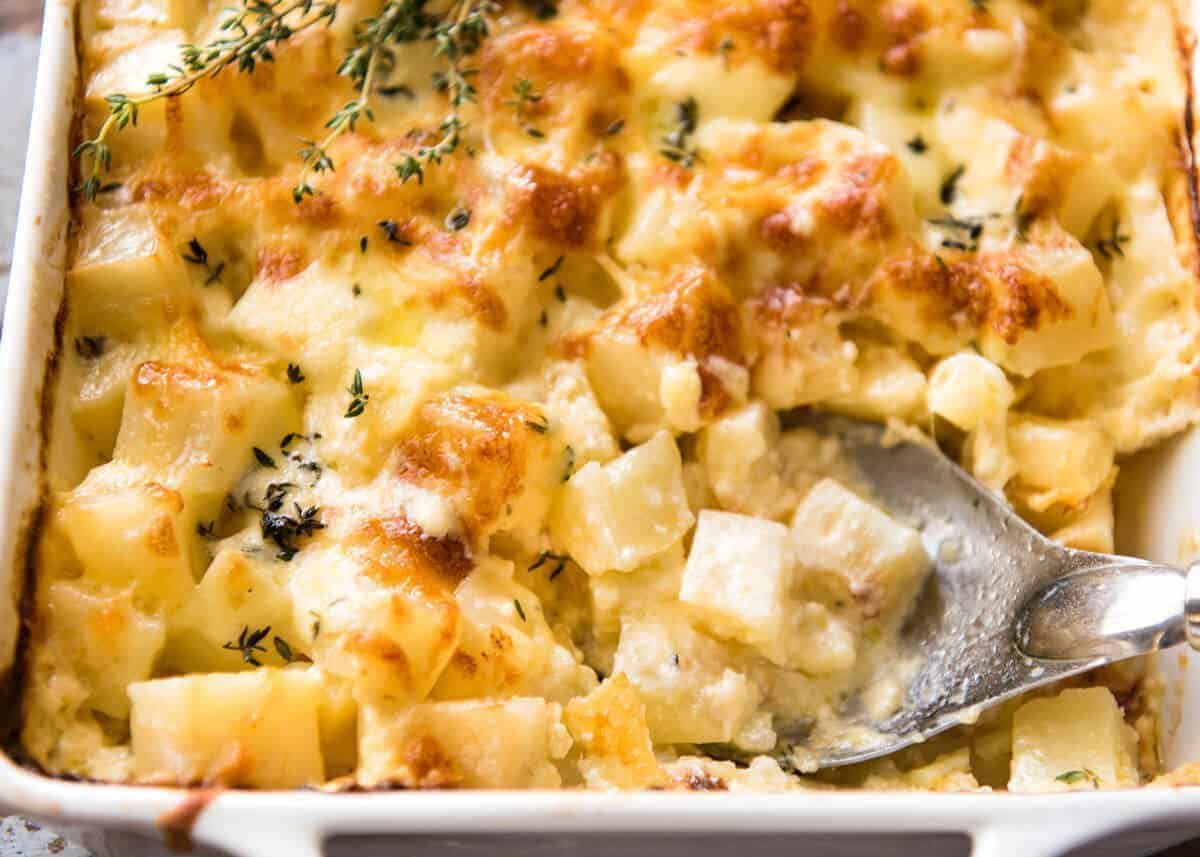 A faster, cheesier, creamier alternative to Scalloped Potatoes / Potato Gratin, this Easy Creamy Cheesy Potato Bake is made with cubed potatoes cooked in a cream and cheese sauce. dev.recipetineats.com