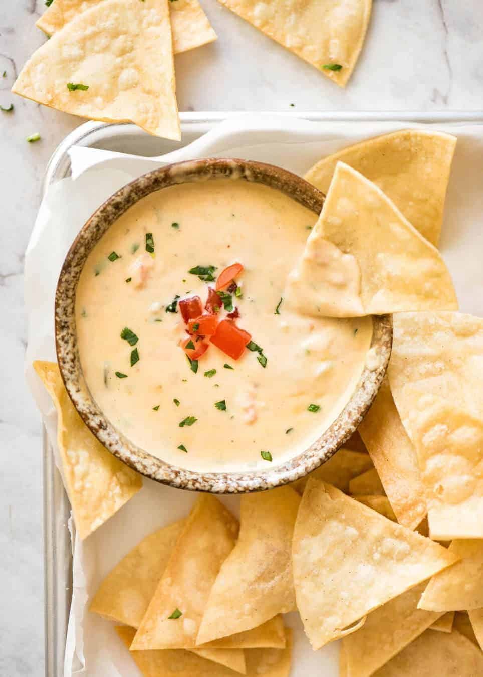 Code cracked: Queso Dip made with real cheese that's ultra silky even when it cools. dev.recipetineats.com