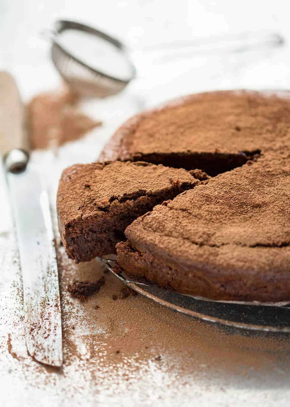 A simple Flourless Chocolate Cake made with almond meal / almond flour. Moist inside, with a thin crackly brownie-like surface. A stunning, very quick cake to make! dev.recipetineats.com