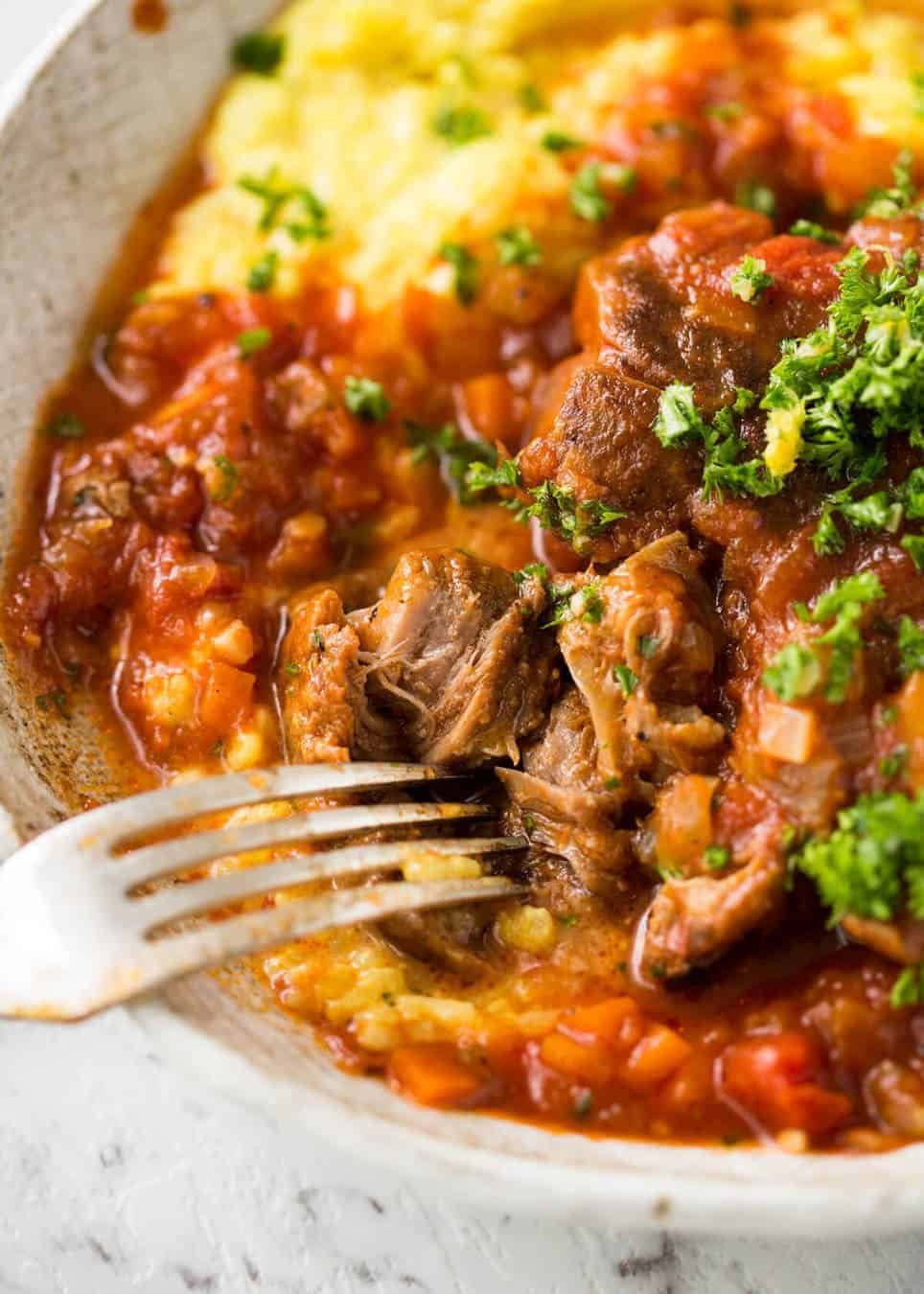 Fork tender veal braised in a rich red sauce, Osso Buco is a meal fit for a king! dev.recipetineats.com
