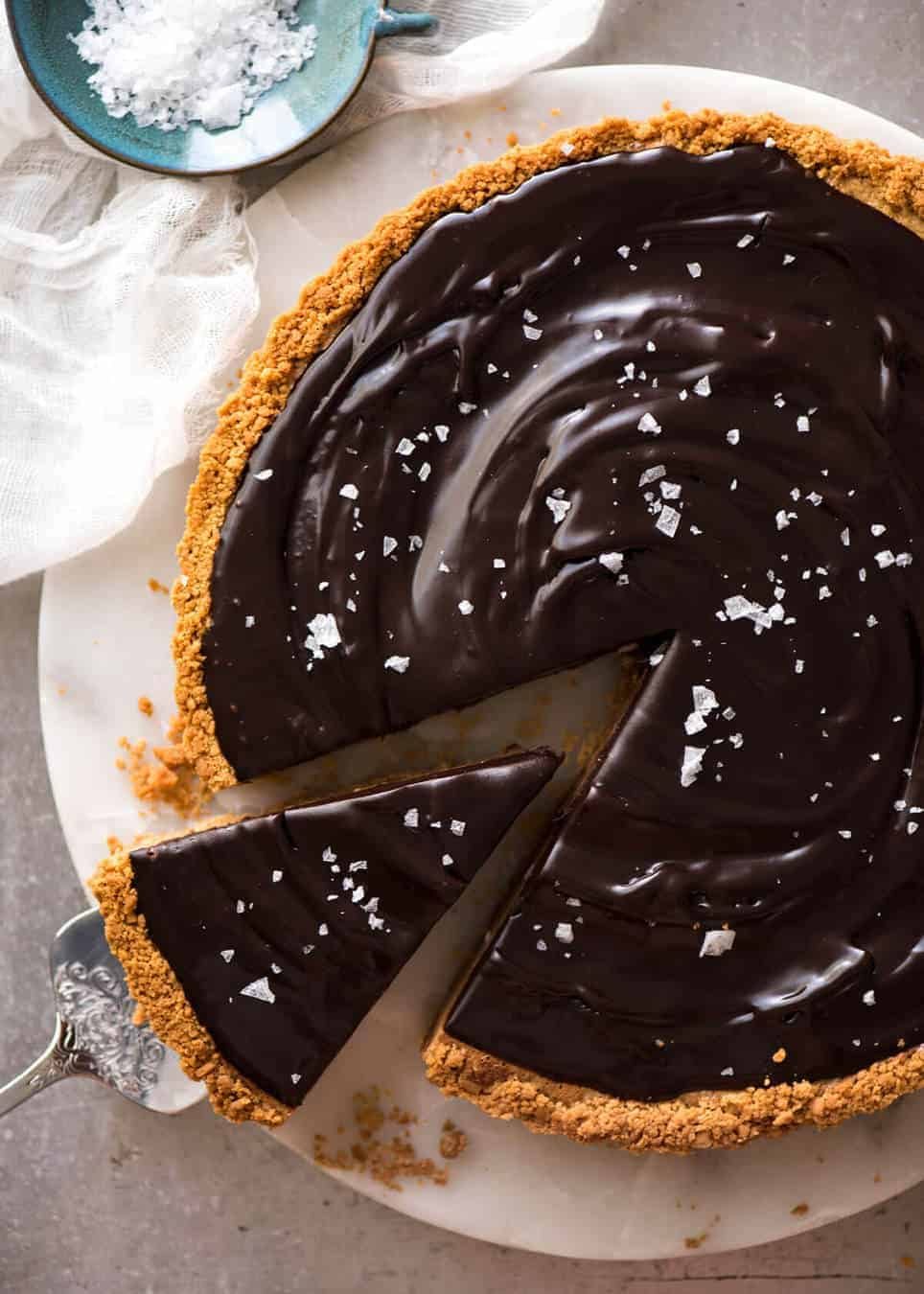 A sinfully decadent Salted Caramel Tart with a creamy soft salted caramel filling topped with luxurious chocolate ganache. Just SIX ingredients! dev.recipetineats.com