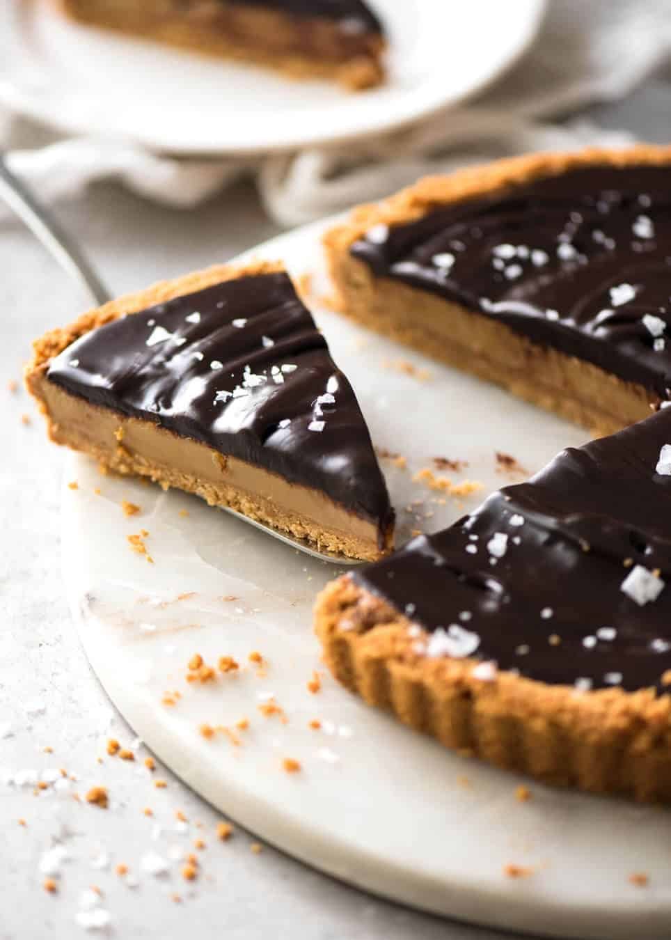 A sinfully decadent Salted Caramel Tart with a creamy soft salted caramel filling topped with luxurious chocolate ganache. Just SIX ingredients! dev.recipetineats.com