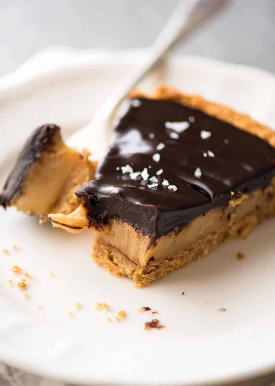 A sinfully decadent Salted Caramel Tart with a creamy soft salted caramel filling topped with luxurious chocolate ganache. Just SIX ingredients! dev.recipetineats.com