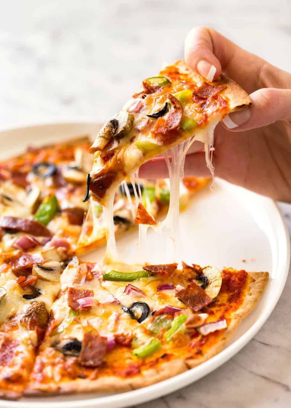 $2 Homemade Frozen Pizzas - quick and easy made using flatbreads, cook from frozen for a terrific Thin & Crispy pizza! dev.recipetineats.com