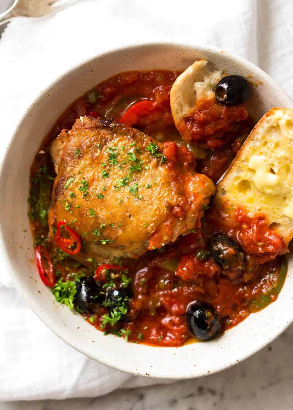A hearty Italian Chicken Casserole with crispy chicken, capsicum / bell peppers, olives and capers. Sicilian style! dev.recipetineats.com