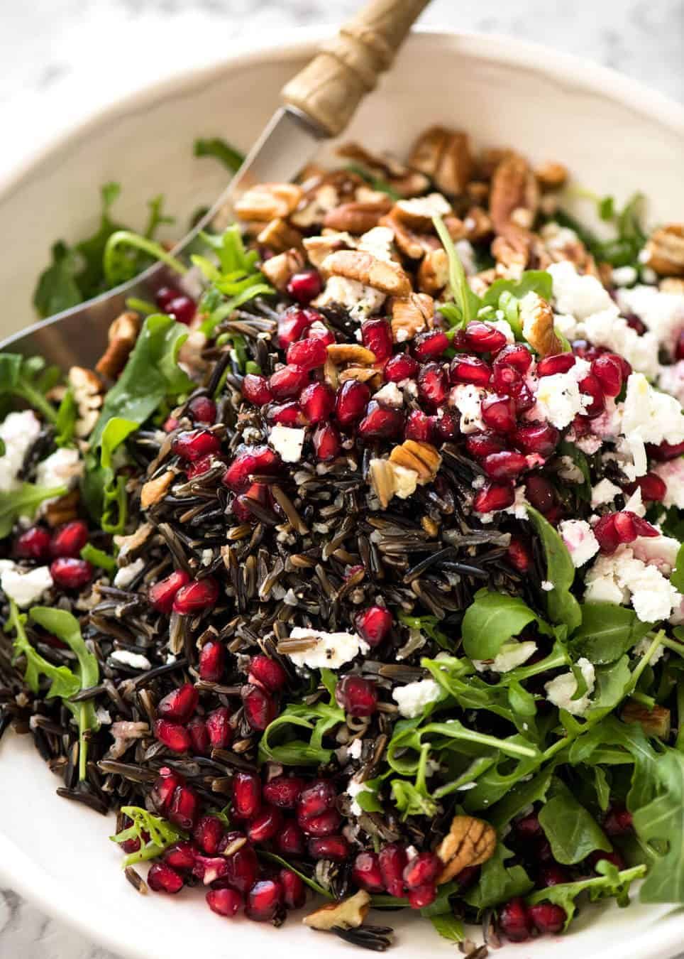 This Wild Rice Salad is a salad for celebrations! Stellar flavour combination - wild rice, pomegranate, pecans, rocket / arugula, green onions, cranberries and feta. dev.recipetineats.com