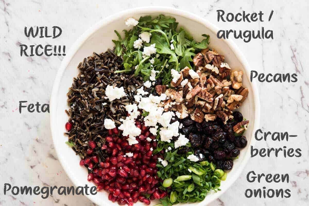 This Wild Rice Salad is a salad for celebrations! Stellar flavour combination - wild rice, pomegranate, pecans, rocket / arugula, green onions, cranberries and feta. dev.recipetineats.com