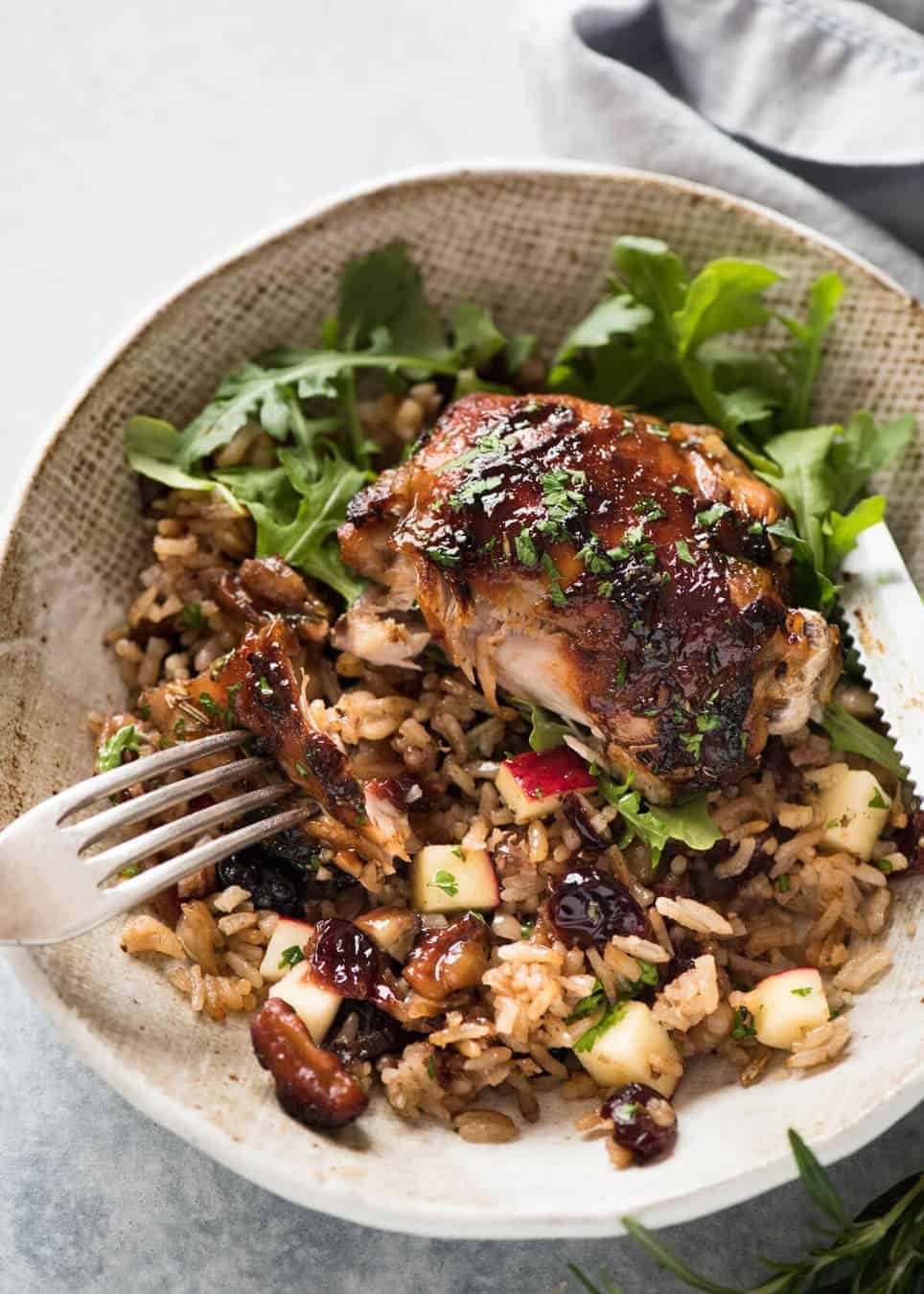 A flavour loaded one-pan, quick midweek dinner - Baked Chicken and Rice Pilaf with Cranberries, Walnuts and Apple. The smell when this is cooking is amazing! dev.recipetineats.com