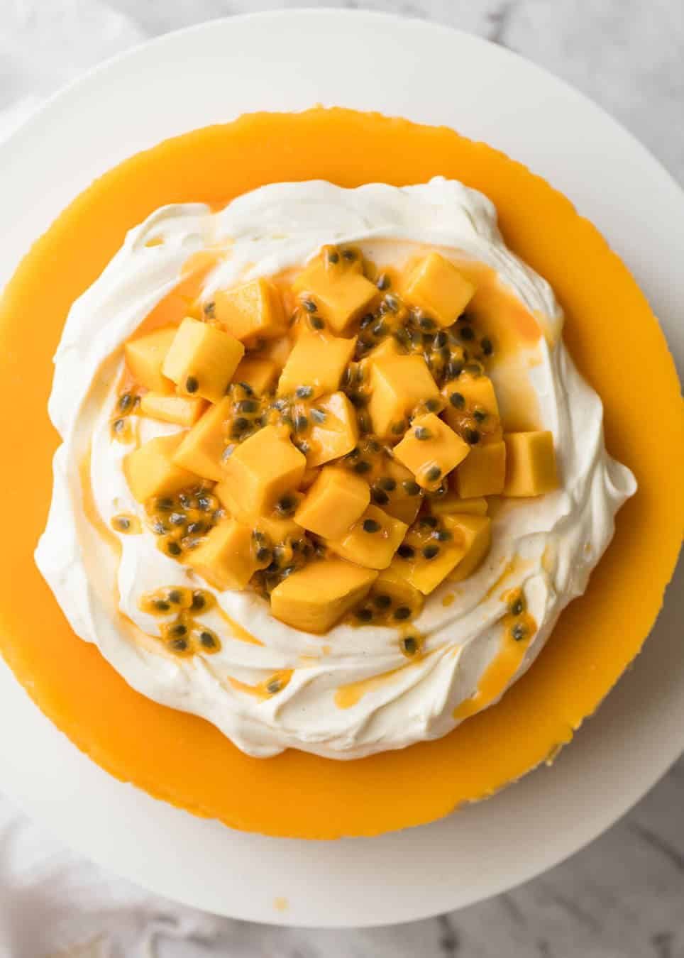 Toppings to decorate mango cheesecake - cream, passionfruit and mangoes. dev.recipetineats.com