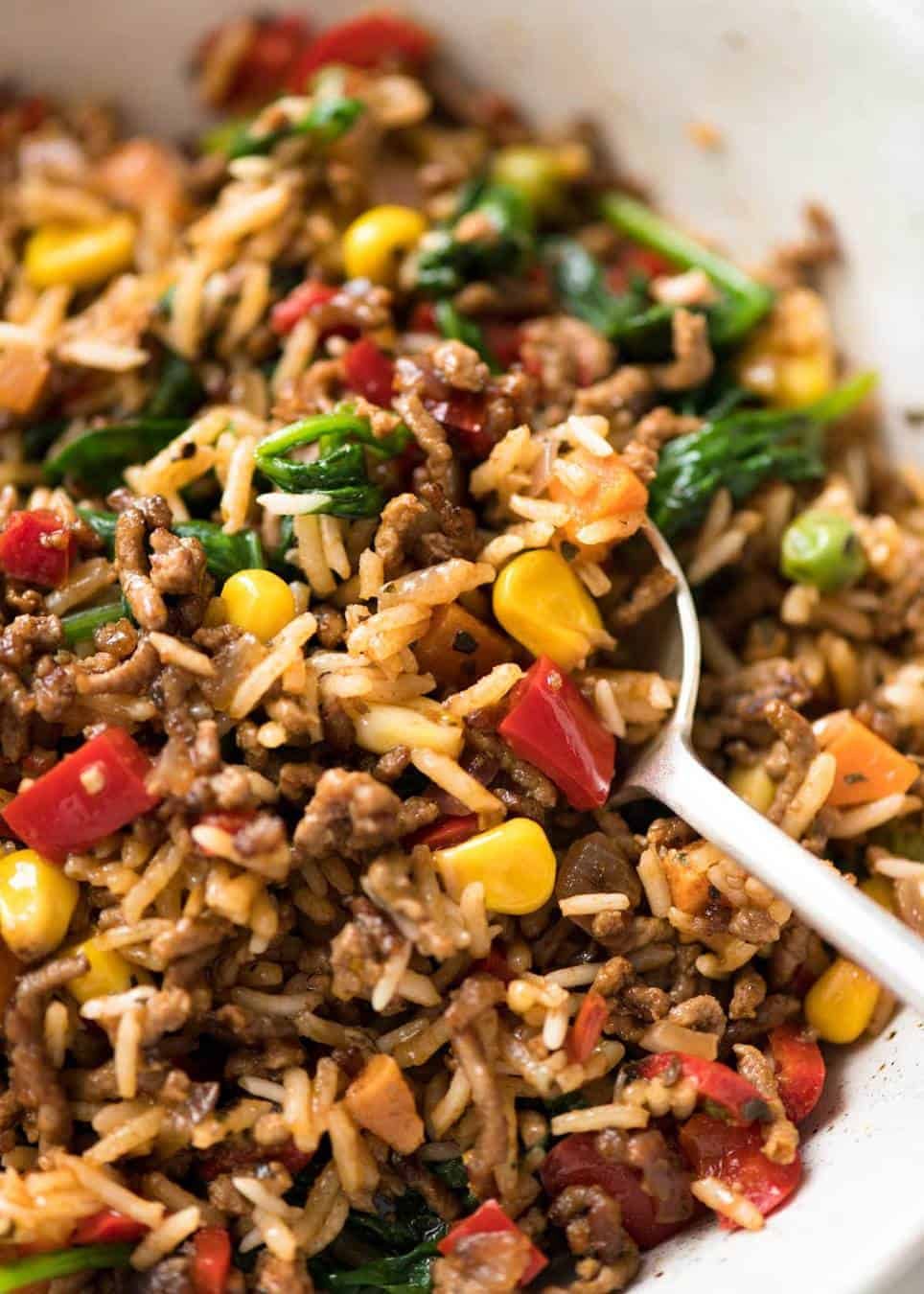 A quick, fabulous midweek meal - this ground Beef and Rice is made by browning ground beef, then cooking it with flavoured rice and loads of veggies. Irresistibly delicious! dev.recipetineats.com
