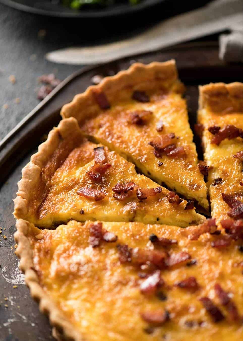 Photo of quiche lorraine on a rustic metal serving tray