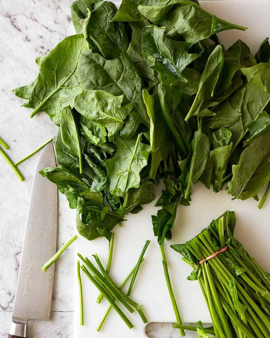 Raw spinach being prepared for Garlic Saut&eacute;ed Spinach