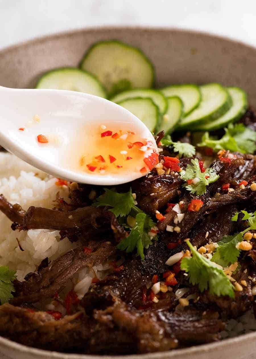 Nuoc Cham sauce being drizzled over Caramelised Vietnamese Shredded Beef