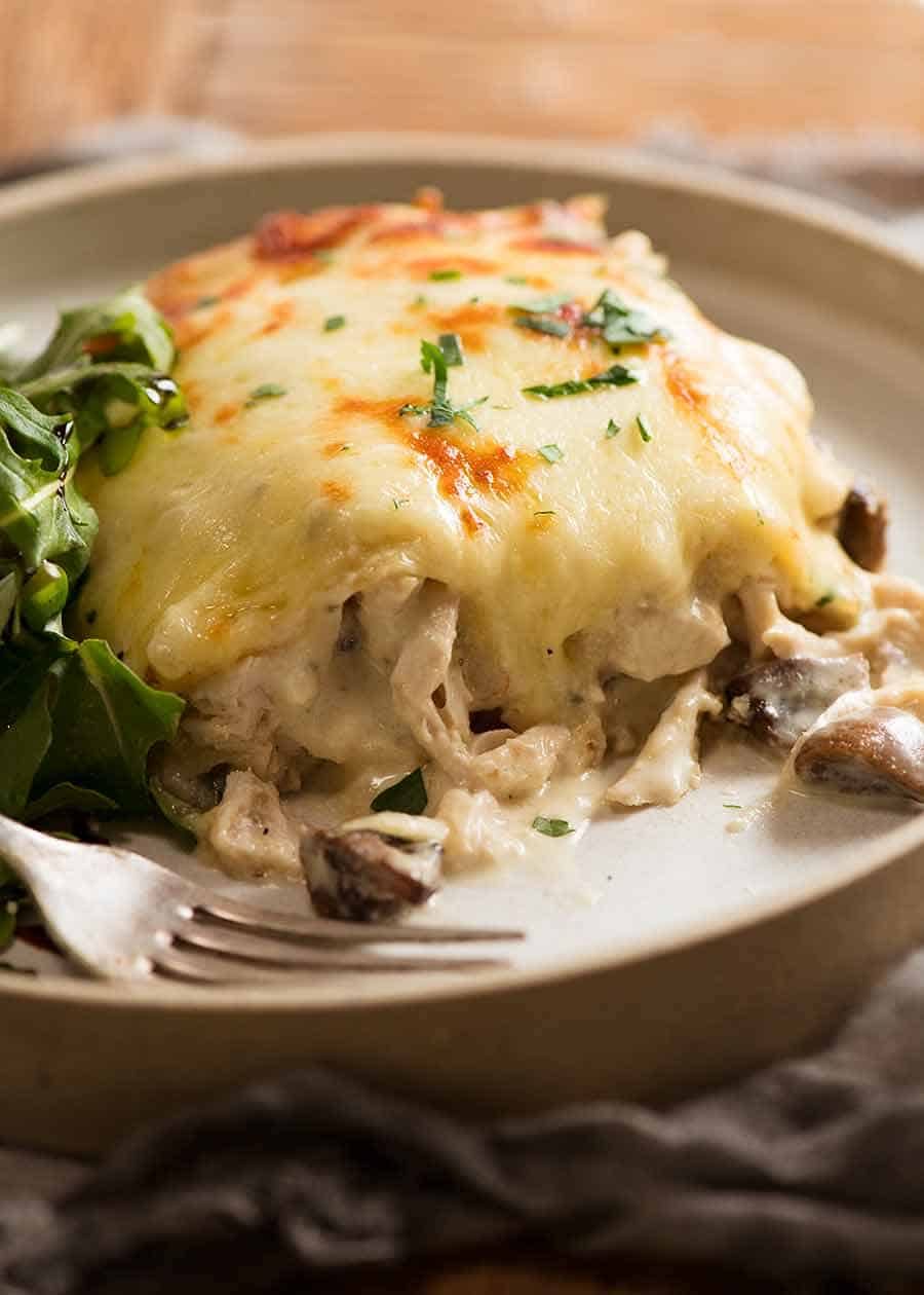 Close up of slice of Chicken Lasagna on a plate, ready to be eaten