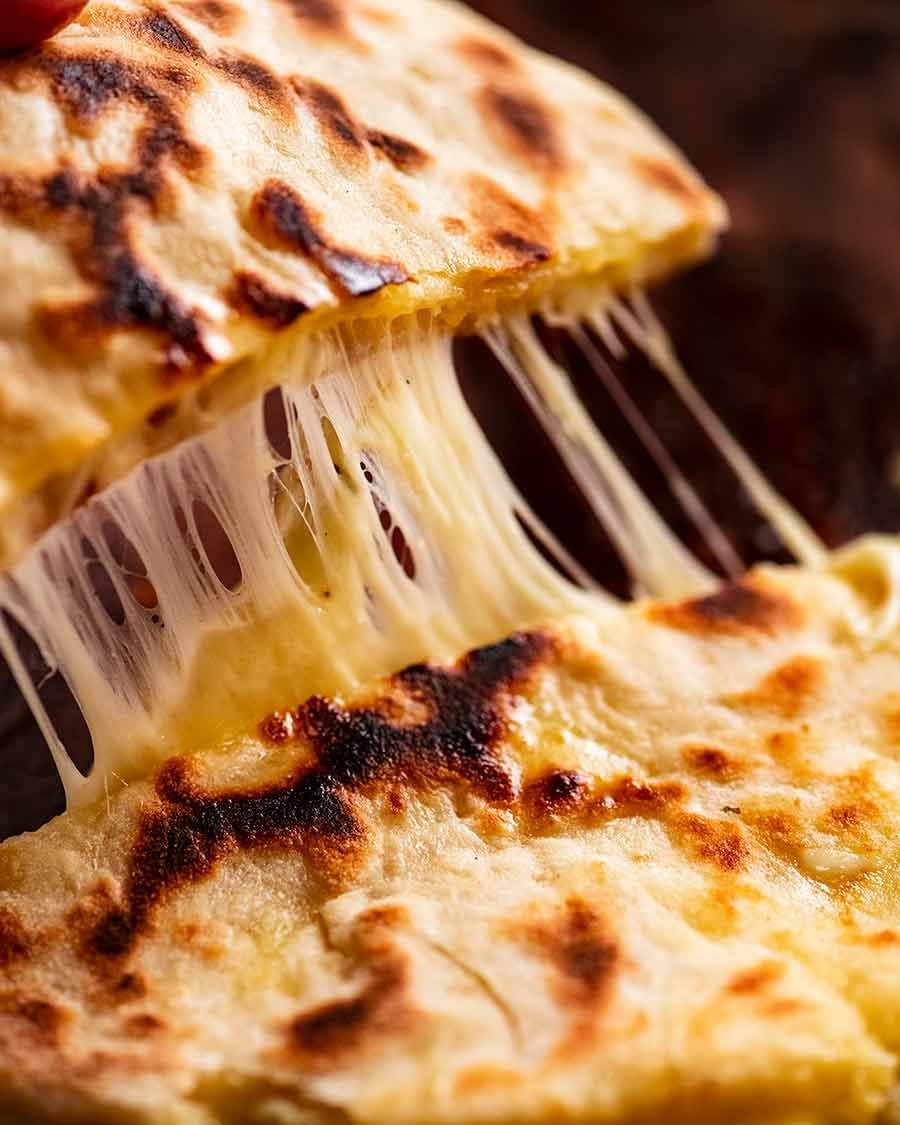 Cheese naan being picked up - cheese pull shot!