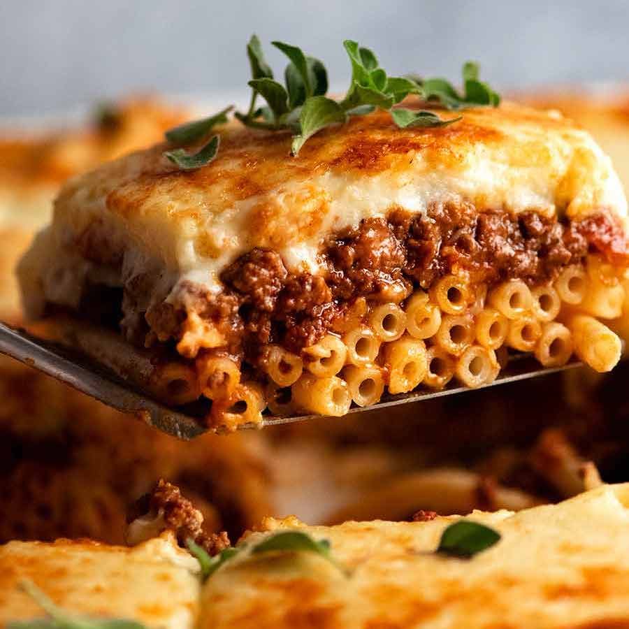 Close up picking up a slice of Pastitsio - Greek Pasta Bake