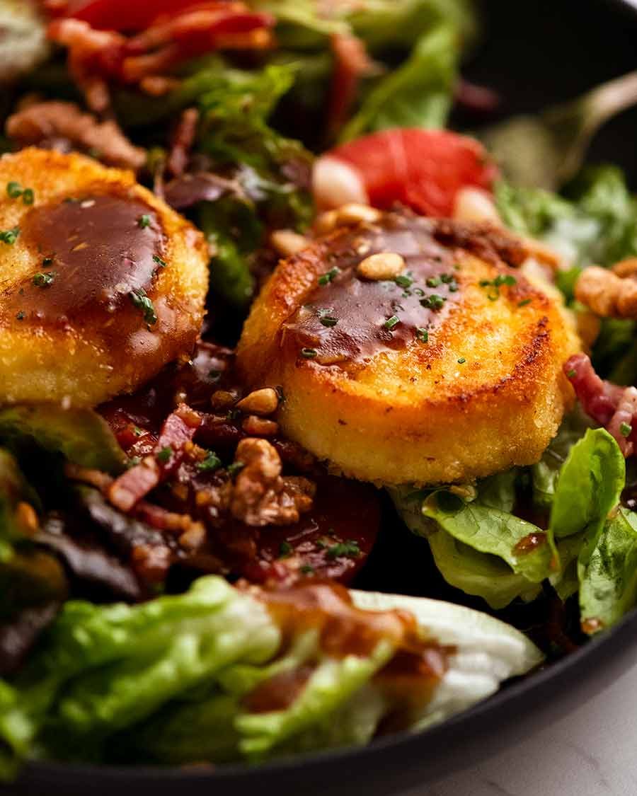 Close up photo of golden pan fried Goat's Cheese on Close up chowing melting inside of French Goats Cheese on Warm French Goat's Cheese Salad (Salade de Ch&ecirc;vre Chaud)