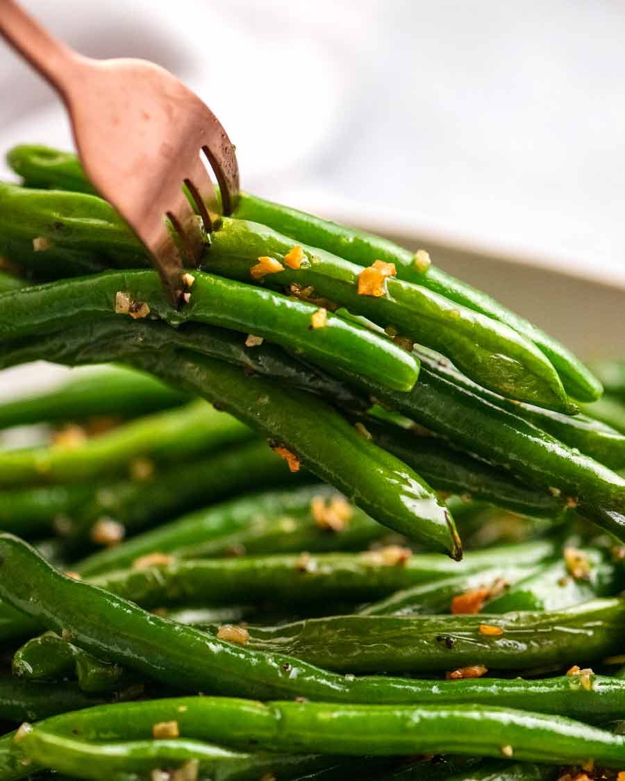 Fork picking up Garlic Saut&eacute;ed Green Beans